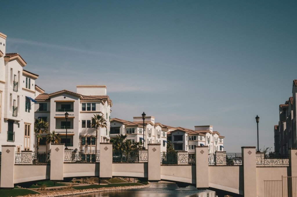 bridge above canal and residential buildings in tropical landscape