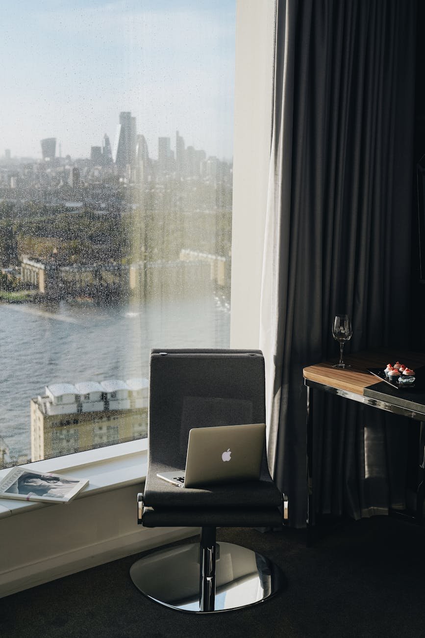 photo of macbook on a gray chair